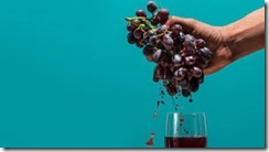 hand squeezing grapes